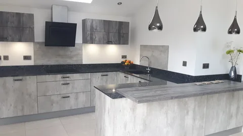 Kitchen with grey stone-effect cabinets and a peninsula